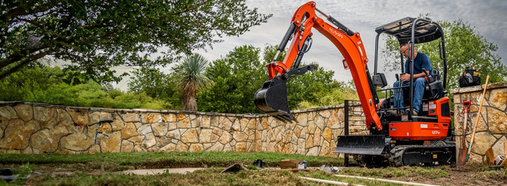 Kubota micro 1.0 780 access with augers, buckets rippers on trailer.